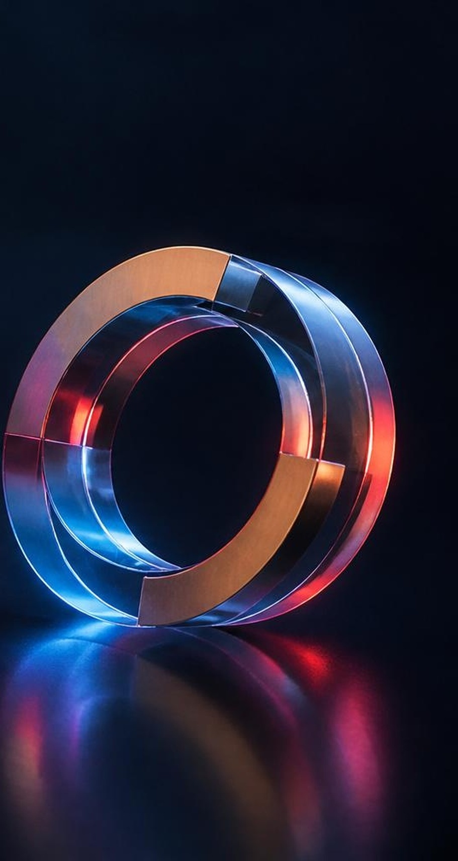 A glass ring form catching blue and amber light, symbolising Sybl's core principles